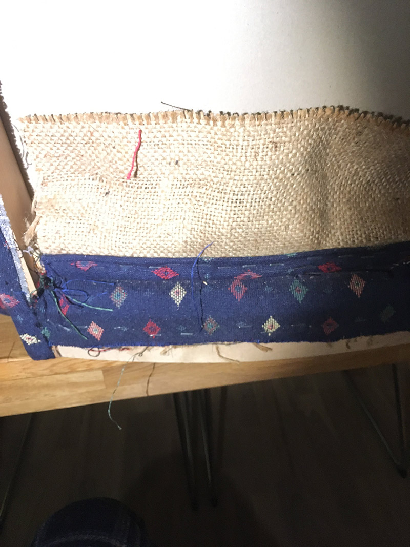 How back support and chair pad fabric is attached at the back